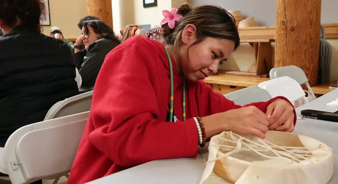 Indigenous student making a weaved basket