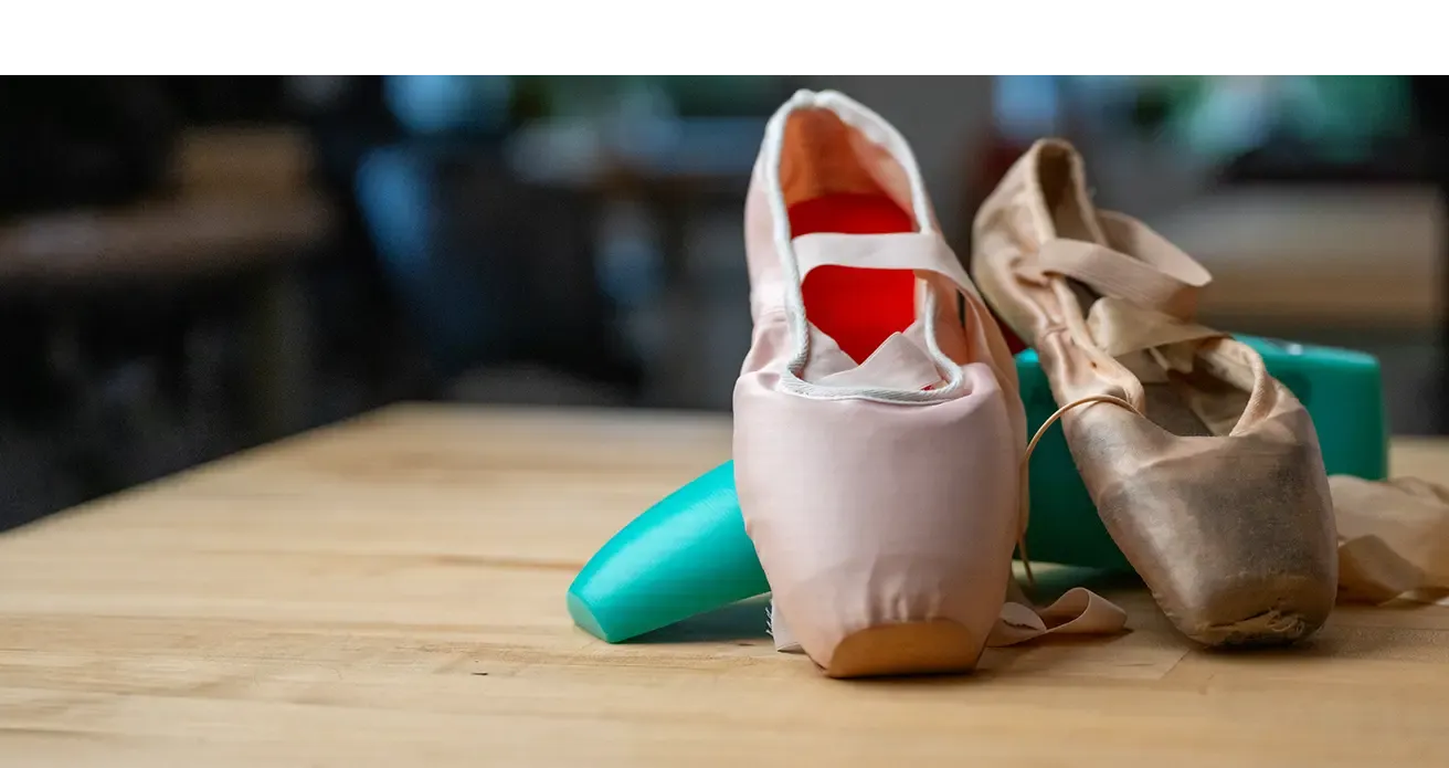 pointe shoes sitting on a table